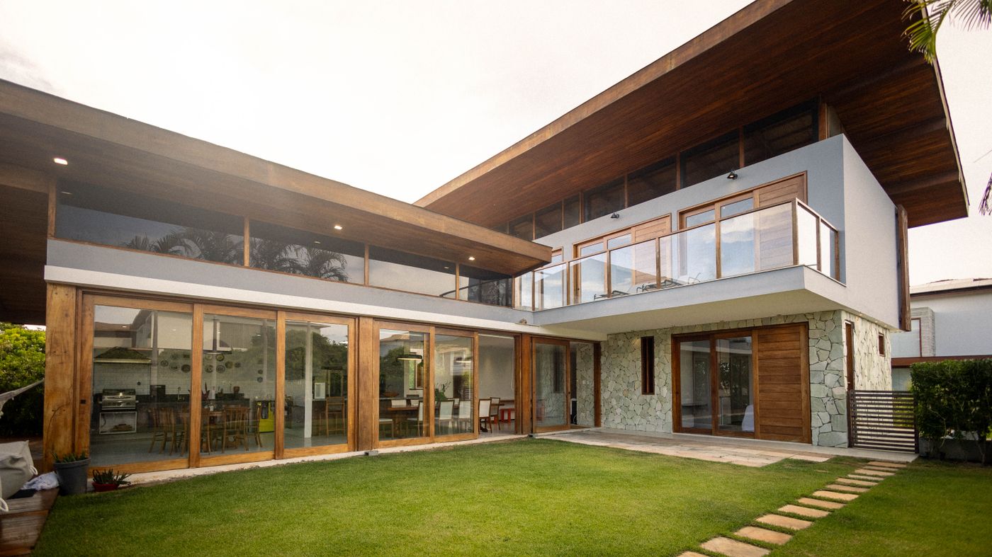 A modern home with floor-to-ceiling glass and timber finishes